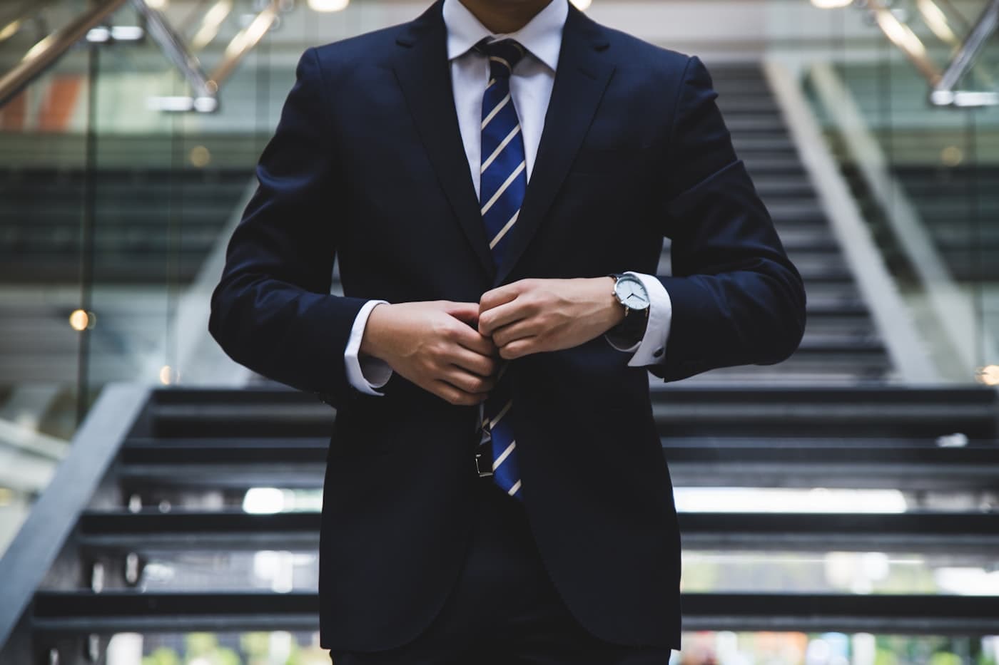 A lawyer in a navy suit in the firm’s lobby.